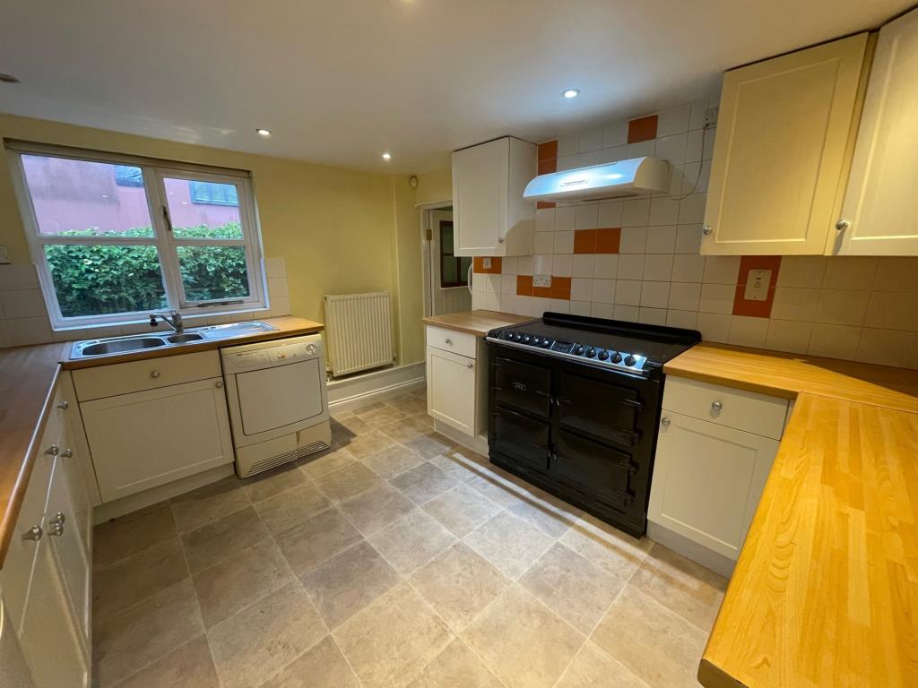 Lot: 132 - CHARACTER COTTAGE IN ESSEX VILLAGE LOCATION - Kitchen with access to garden and utility room/WC